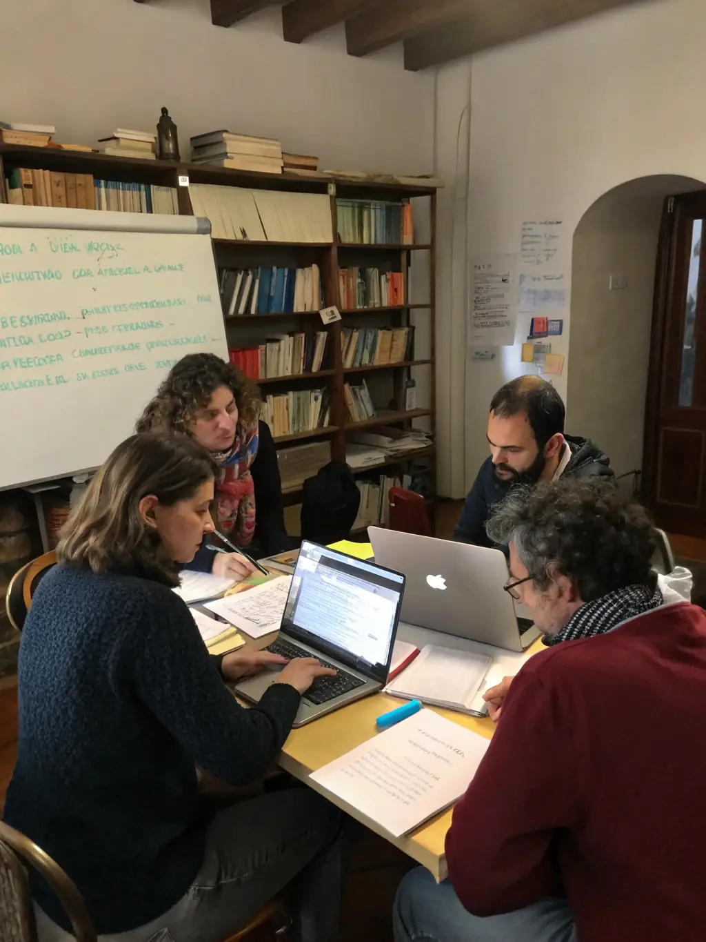 A group of teachers collaborating on lesson plans and sharing resources through a high-speed, reliable network connection. The setting is a modern teacher's lounge.